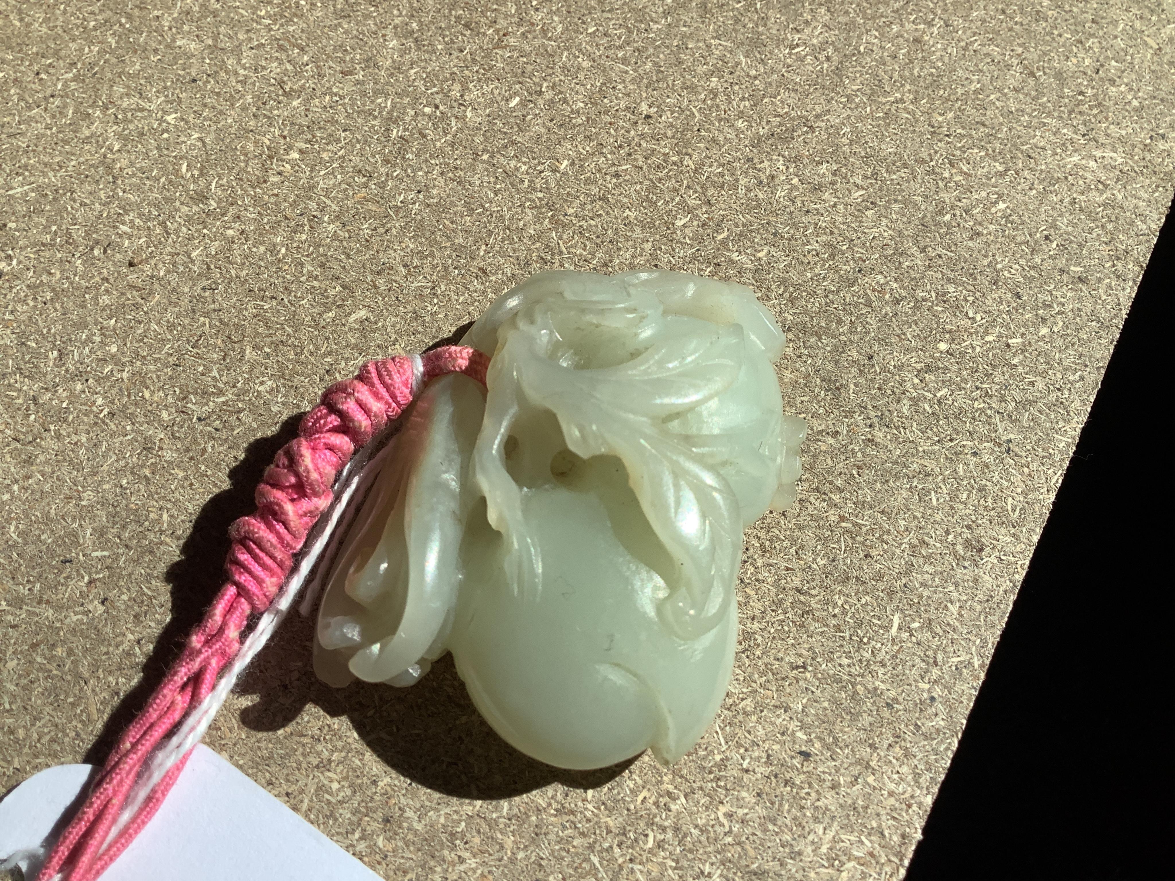 A 19th century jade carving of fruit, 5.5cm wide. Condition - fair, a small piece missing